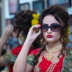 Woman Wearing Red Dress Holding Her Black Framed Sunglasses