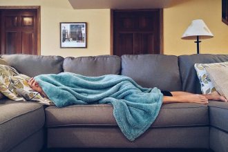 Person Lying on Sofa